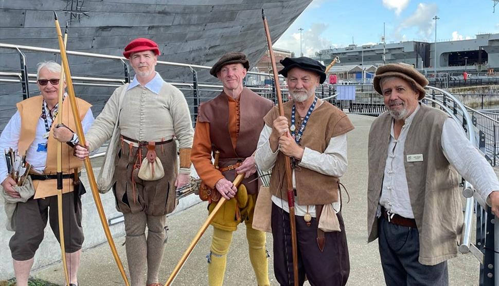 Archers gathered outside The Mary Rose in Tudor wear.