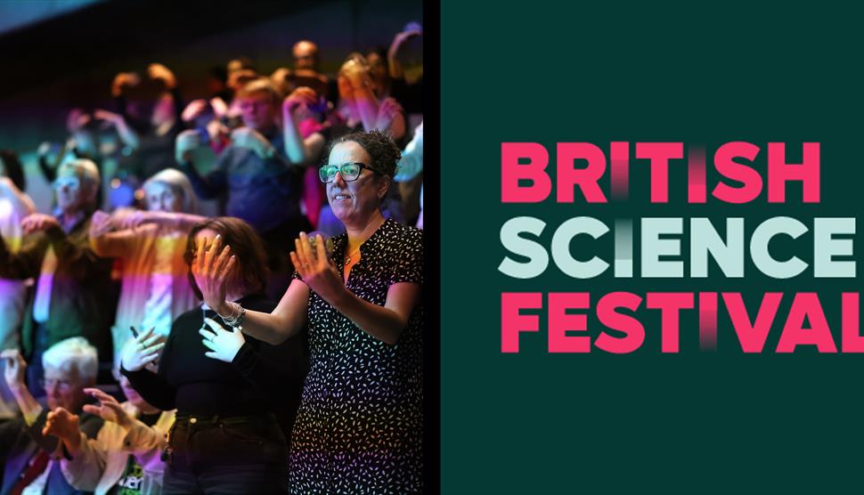 Audience members participating in an interactive activity under colourful stage lighting, alongside the British Science Festival logo.