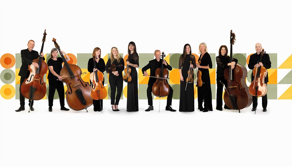 The BSO Strings Ensemble are holding their instruments in front of a background of graphic shapes