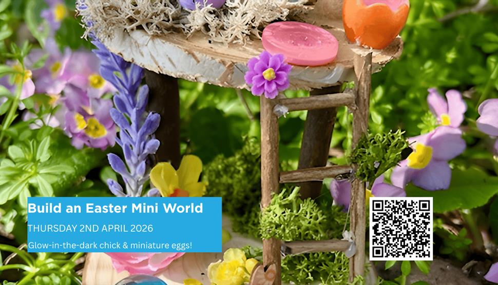 A miniature Easter craft house made from mini wooden pieces, twigs, ferns and flowers and decorated with colourful buttons and glowi n the dark chick