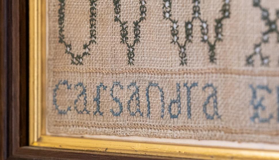 Sewing circle at Jane Austen's House. Sampler by Cassandra Austen at Jane Austen's House.