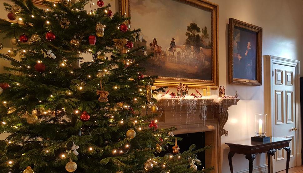 Inside one of the rooms at Stansted House, decorated for Christmas with a tree by the fireplace