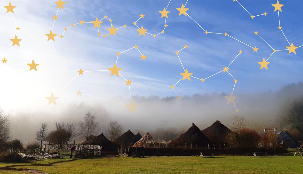 A starry sky of constellations over the roundhouse roofs of Butser Ancient Farm.