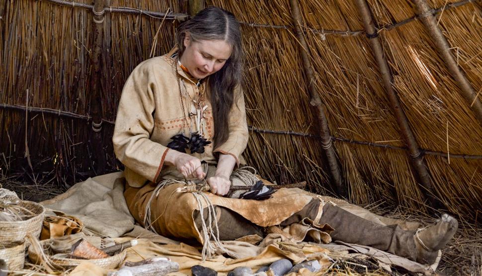 Woman flintknapping in bronze age.