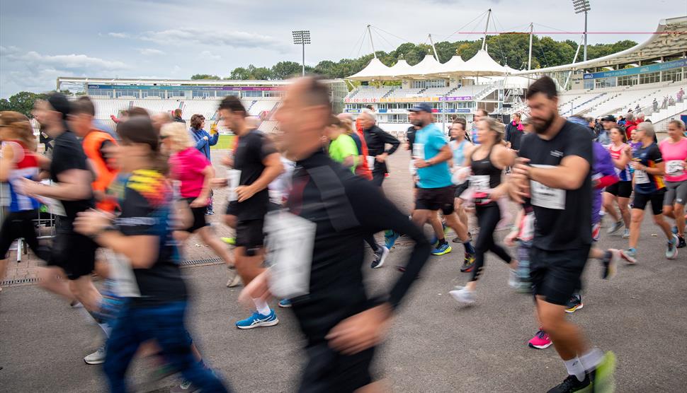 Runners at Utilita Bowl in front of the Rod Bransgrove Pavilion