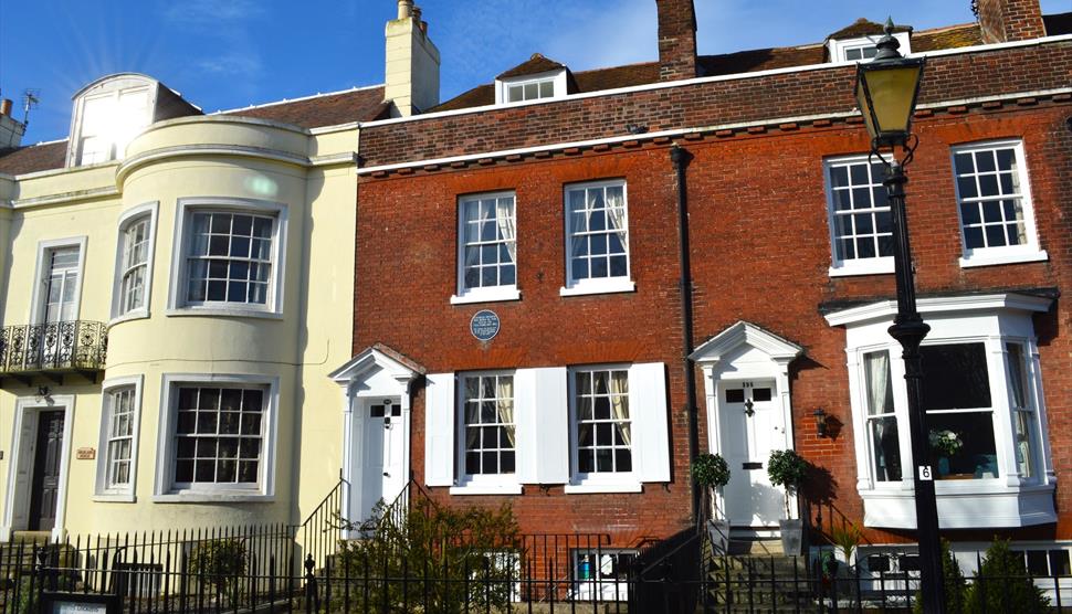 Photograph showing the exterior of the Charles Dickens' Birthplace Museum under a blue sky