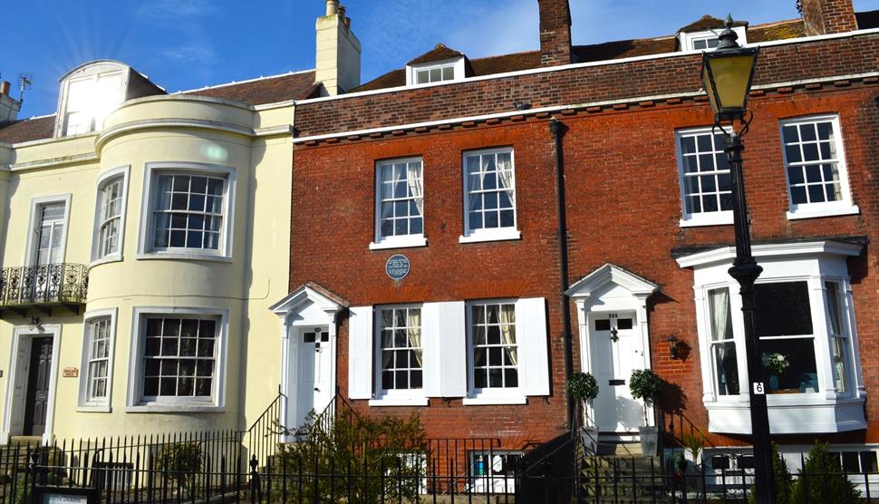 Photograph showing the exterior of the Charles Dickens' Birthplace Museum under a blue sky