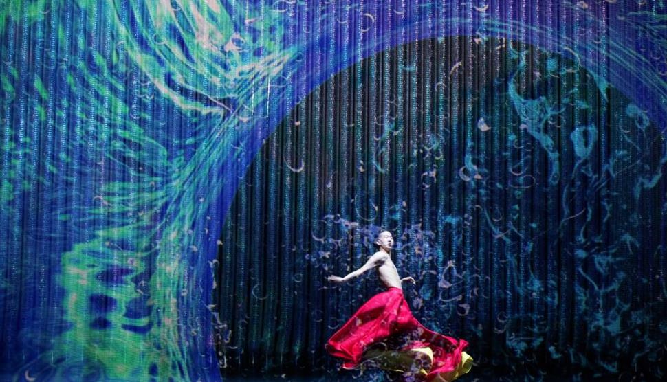 Dancer stands under wave