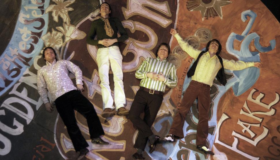 Photograph showing the four members of The Small Fakers
