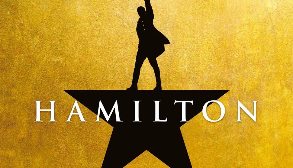 Black star on a gold background. Top point is a man pointing up.