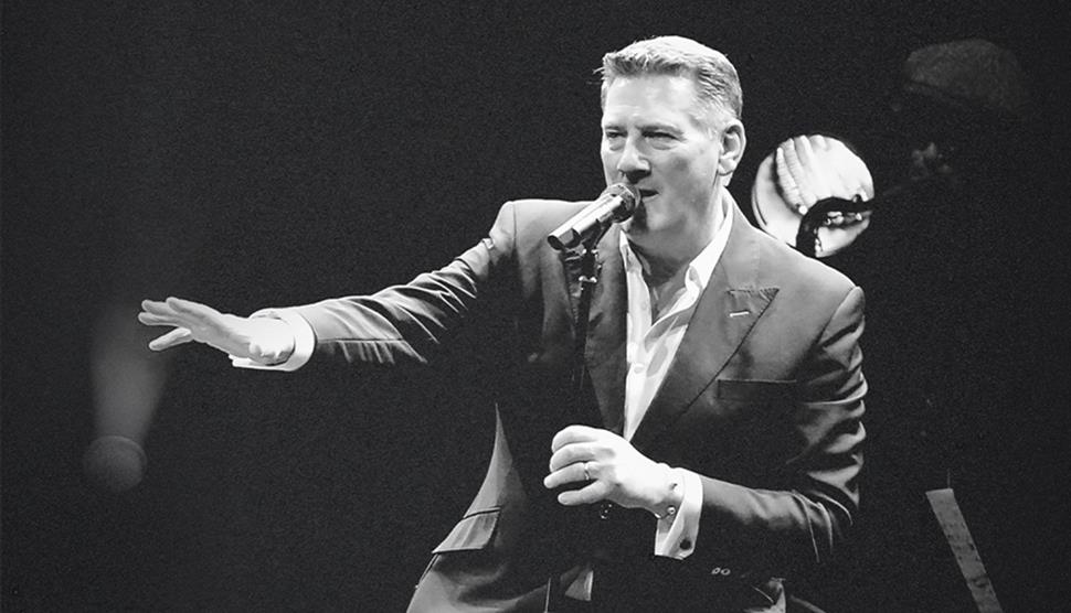 Black and white photograph of Tony Hadley mid-performance
