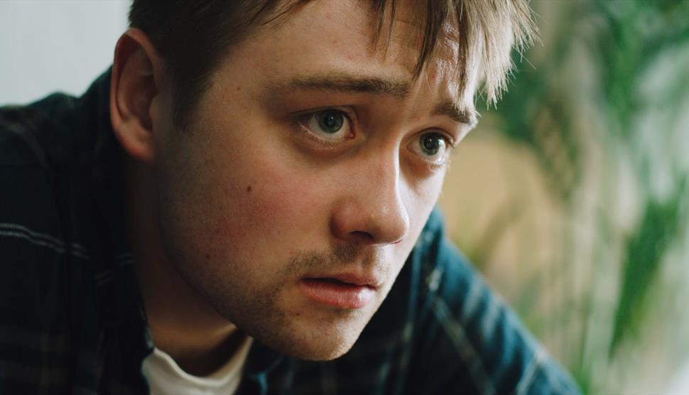 Close up of a wide-eyed young man