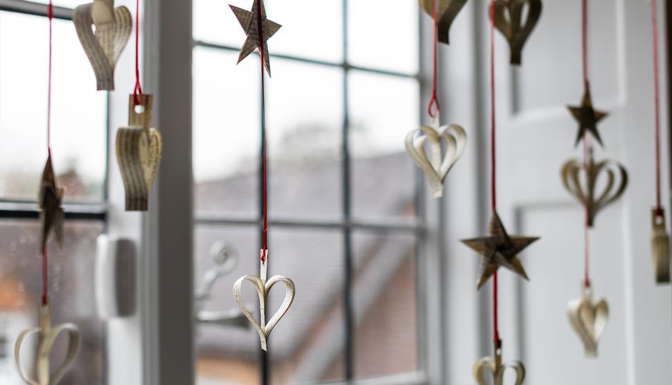 Paper decorations hanging in the window at Jane Austen's House