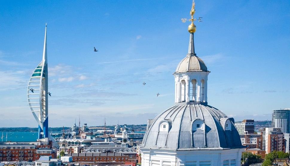 Top of Portsmouth Cathedral from the air, with the Spinnaker Tower in the background