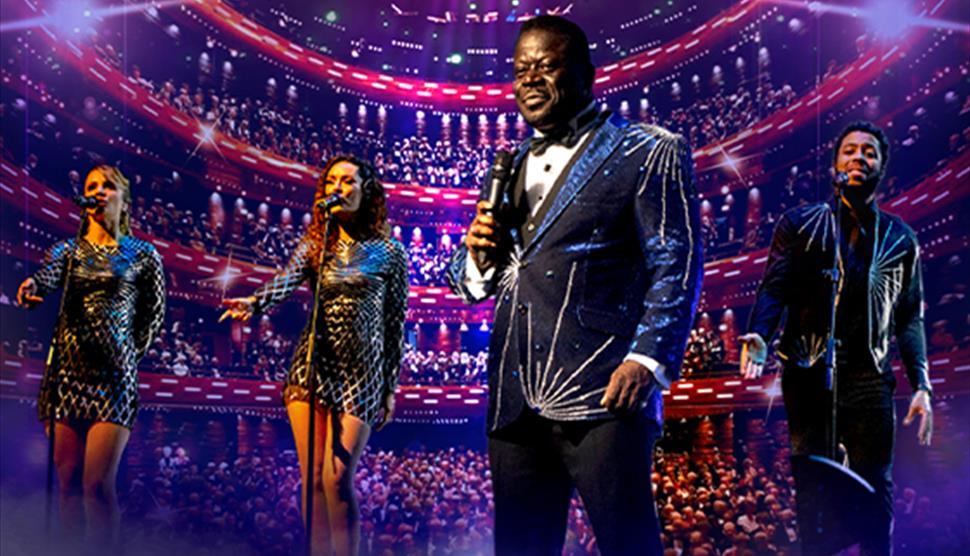 A vibrant concert scene with a Luther Vandross tribute dressed in a sparkling suit, holding a microphone. He is accompanied by three backup singers, a