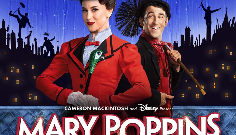 Woman in red jacket and men dress as chimney sweep stood in front of London skyline