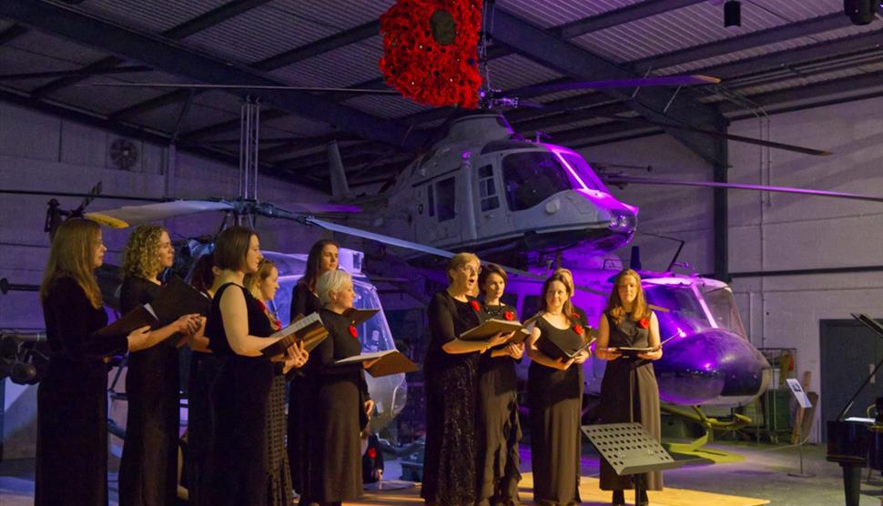 Image of the Middle Wallop & Andover Military Wives Choir performing at the Army Flying Museum