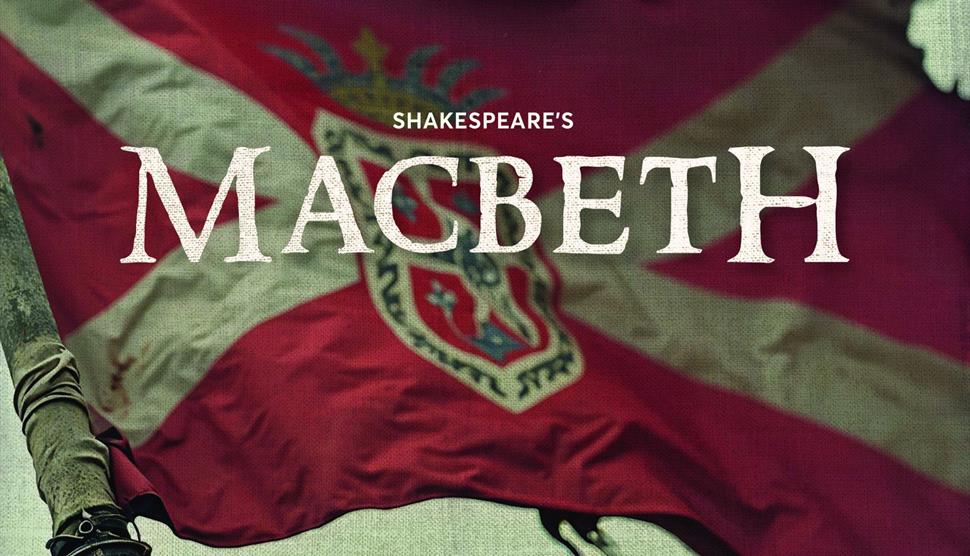A flag billows in the wind with the words 'Shakespeare's Macbeth' appearing in the centre.