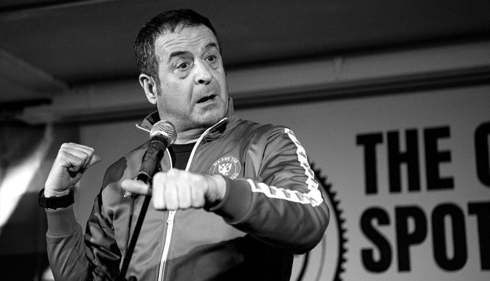 Black and white photograph of Mark Thomas performing stand up
