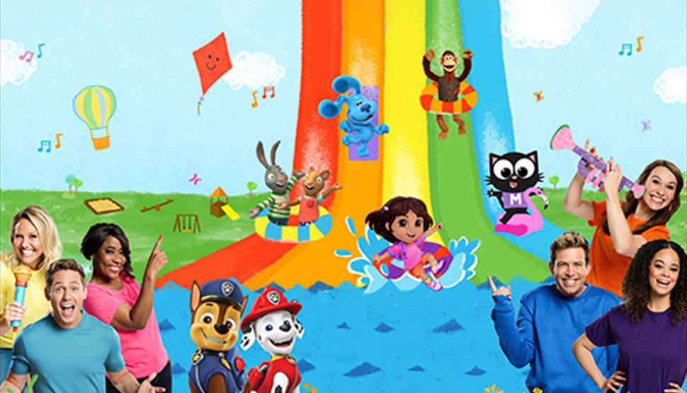 A rainbow slide with a host of Milkshake! characters on a rainbow slide and six of the presenters either side