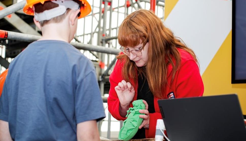 A woman showing a child one of the pests which could impact the ship.