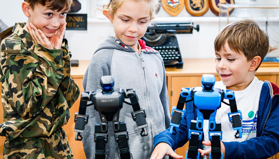 Visitors play with robots in the Victory Gallery