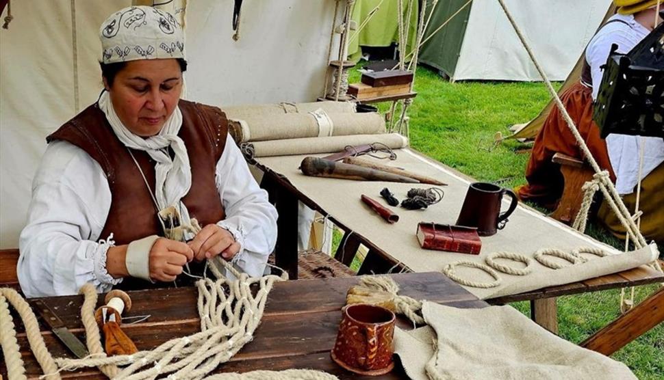 Sarah Liscoe making a historical sail using traditional techniques