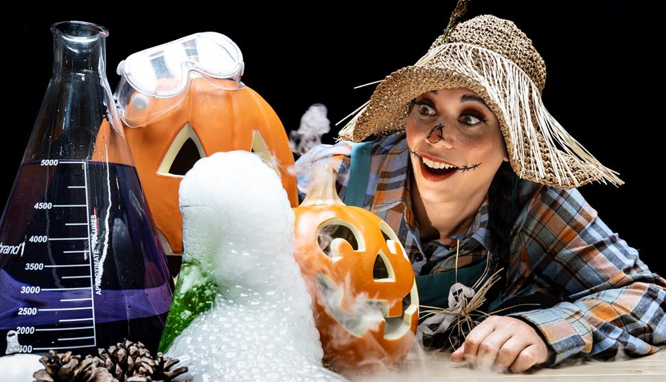Scarecrow looking at pumpkins and smoke with a wowed expression