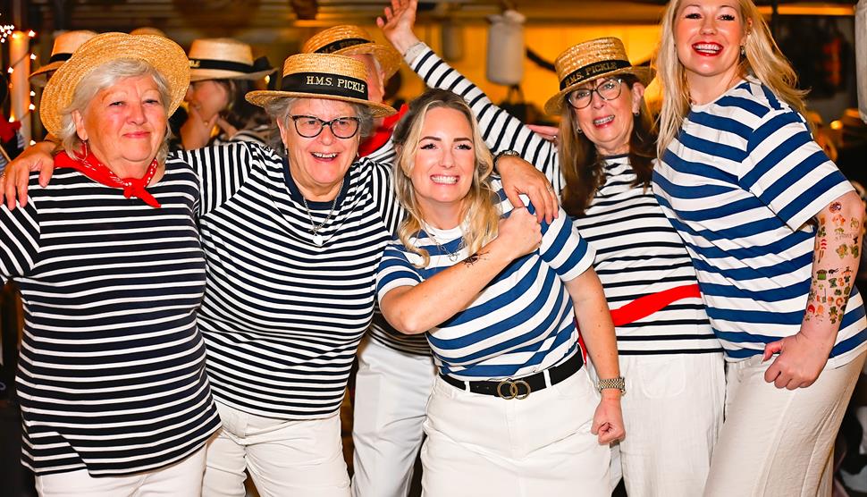 Group of people dressed up for Pickle Night on HMS Warrior