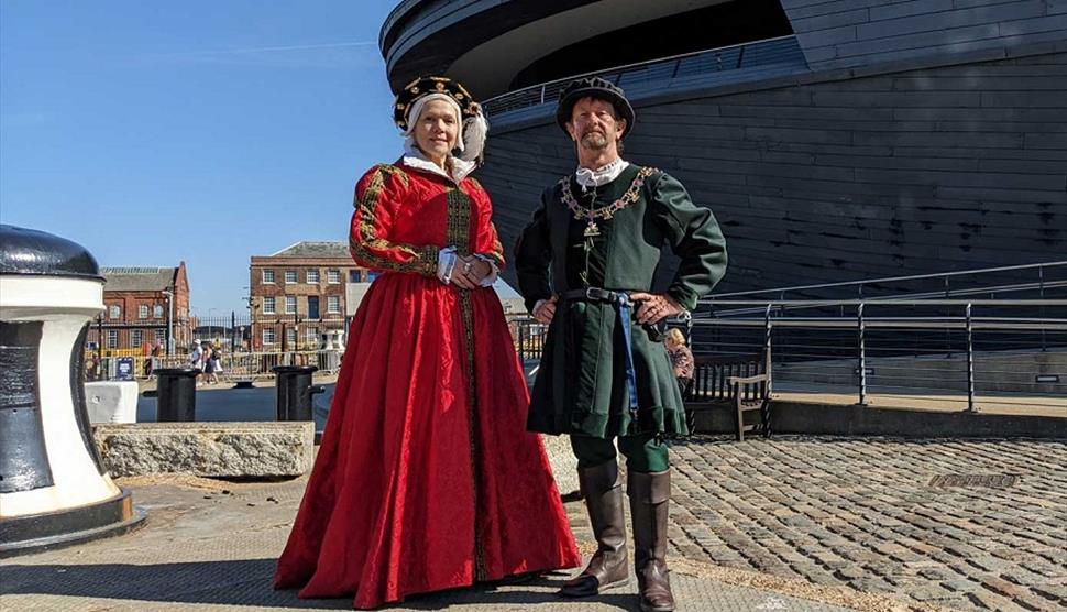 Re-enactors in Tudor dress outside The Mary Rose museum