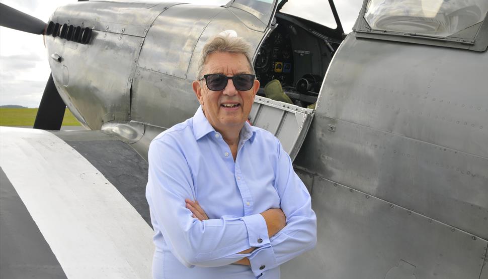 Paul Beaver (Author and Historian) pictured with a Spitfire