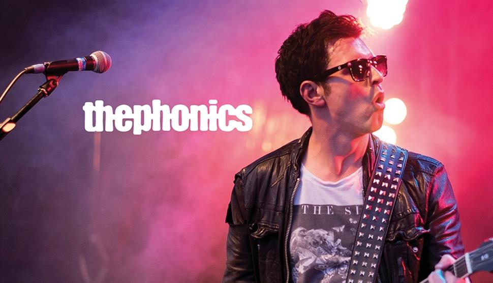 Poster for The Phonics, showing the lead singer mid-performance