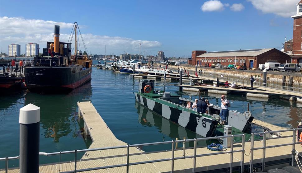 People on a boat at a Pontoon Open Day outside Boathouse 4