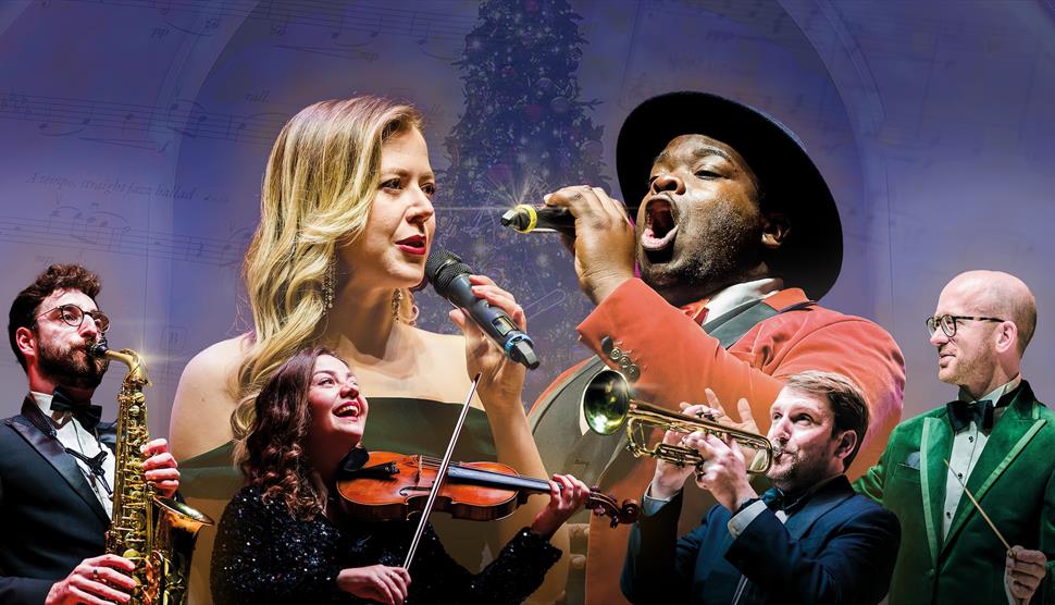 Vocalists and instrumentalists in front of a Christmas tree
