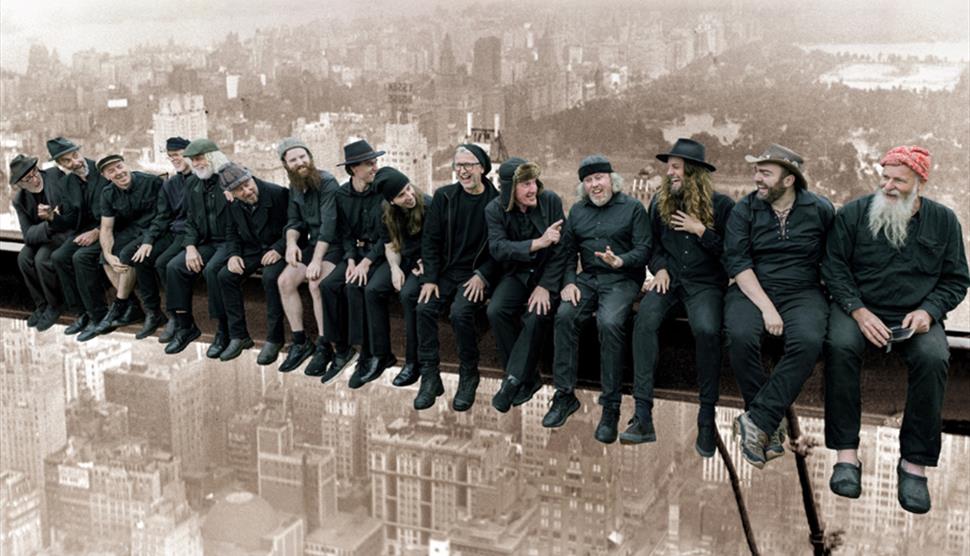 Photograph of the Spooky Men's Chorale, aping the famous New York Girder image