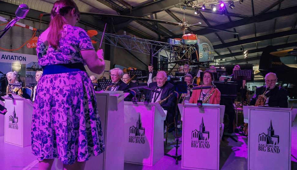 image of Salisbury big band playing their instruments at a concert at Army Flying Museum