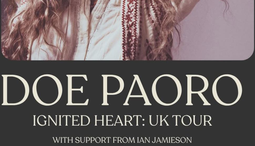 Promotional poster for Doe Paoro's "Ignited Heart: UK Tour," featuring a close-up portrait of a woman with long curly hair wearing a white embroidered