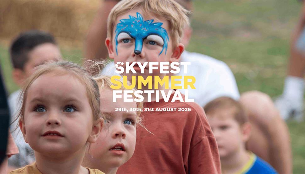 Children in face paintingwatching entertainment at SkyFest Summer at Sky Park Farm in West Harting.
