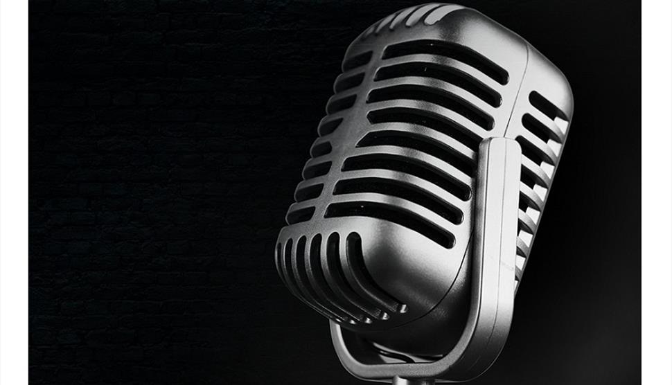 Stock image of a microphone on a black background for the Solent Hotel & Spa's tribute evenings