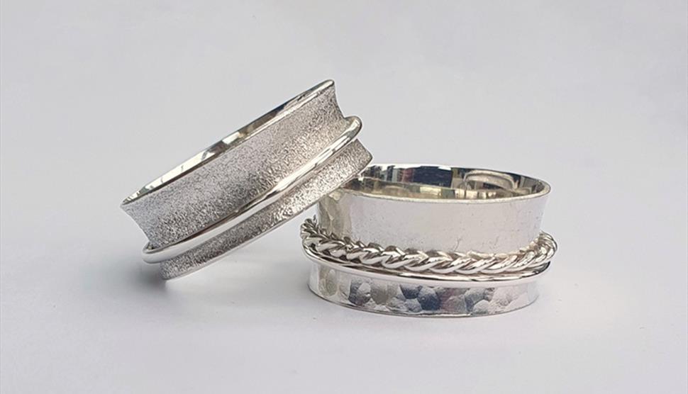 Two silver spinner/worry rings