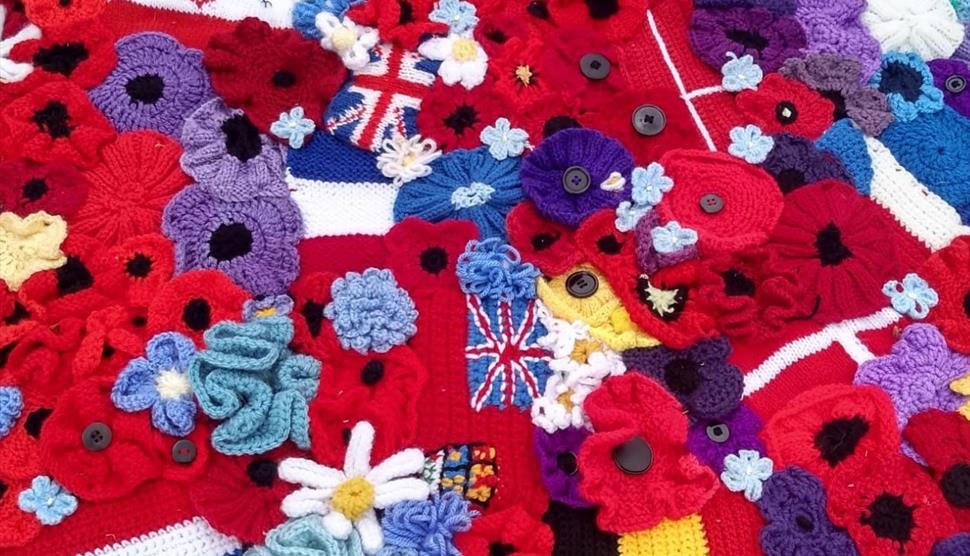 Close-up of handcrafted remembrance flowers from The Longest Yarn Remembrance Cascades, featuring symbolic blooms honouring Second World War stories a