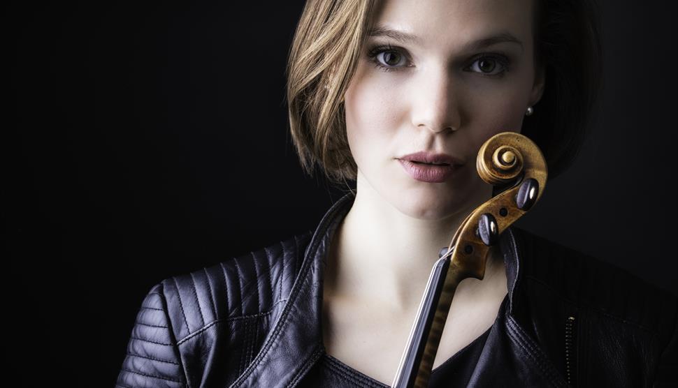 Tamsin Waley-Cohen looks at the camera holding her violin.