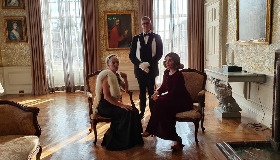 Three people in regency wear at Stansted House