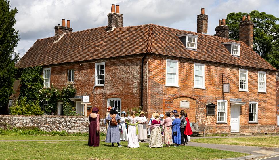 Visitors outside Jane Austen's House about to depart on the village walk