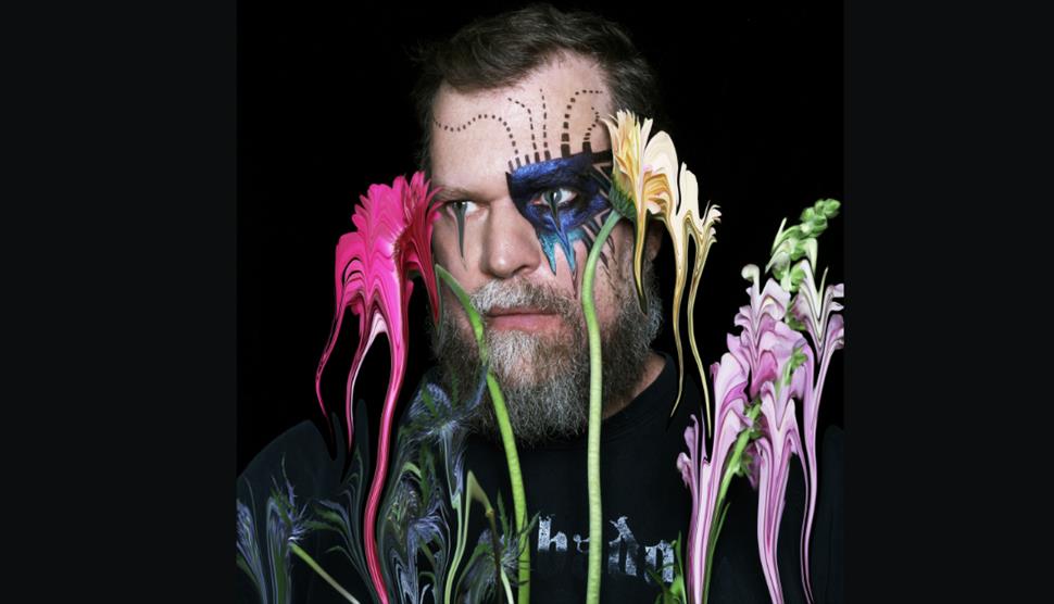 Picture of singer John Grant with flowers.