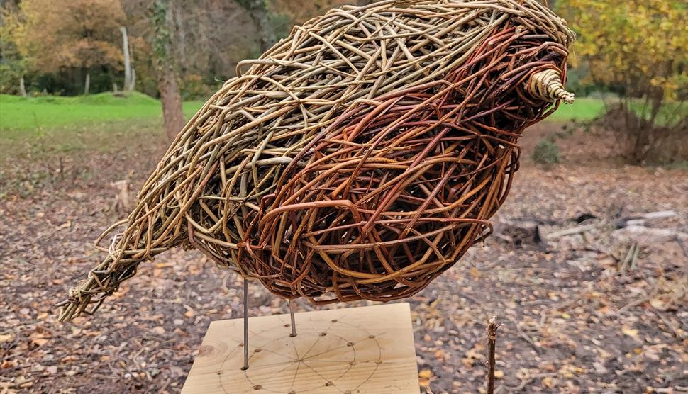 willow robin sculpture on wooden block