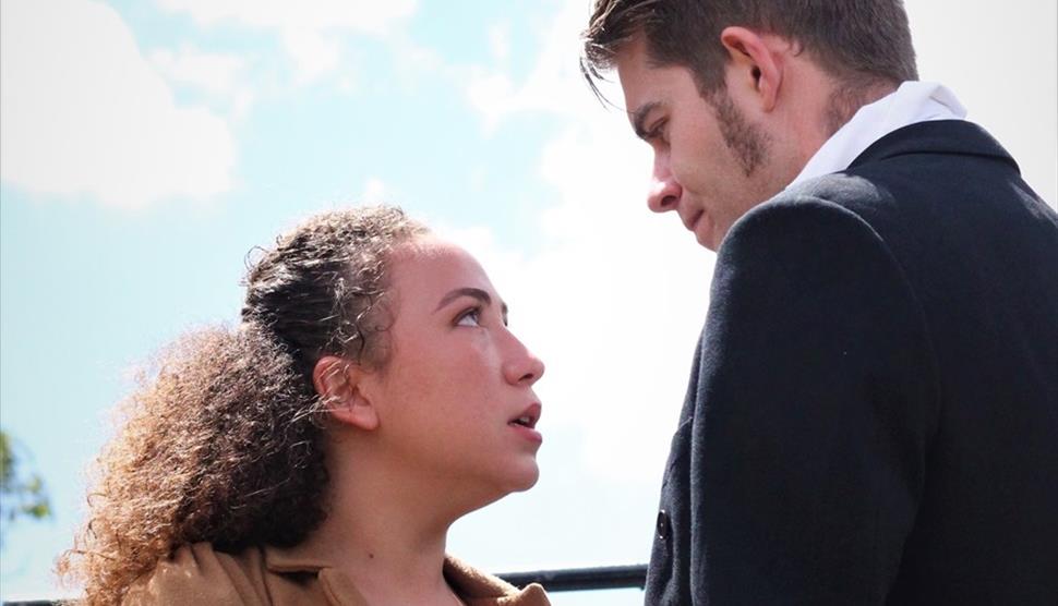 A man and woman from a production of Pride and Prejudice.