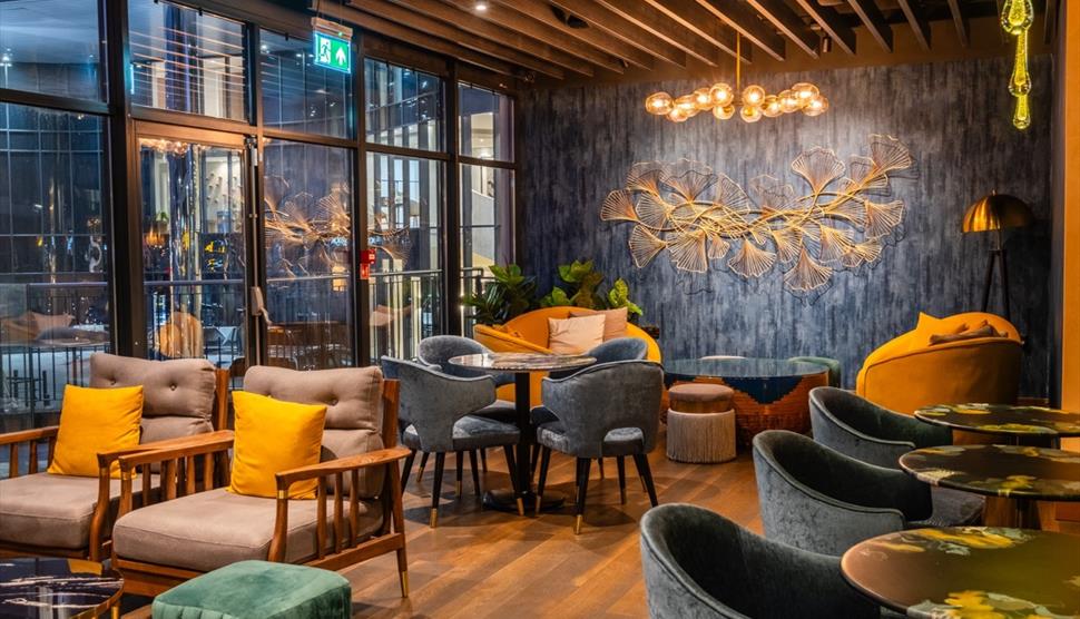 Seating area of Blue Jasmine restaurant with tables and chairs