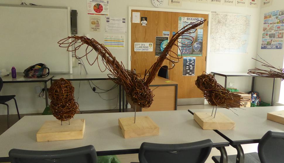 students willow owl sculptures placed on a table