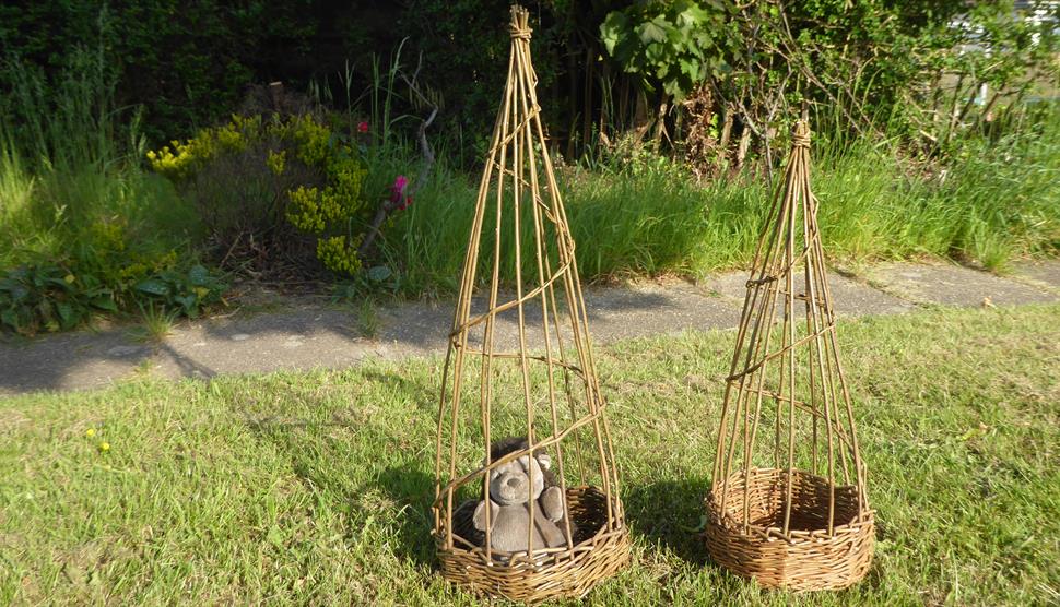 two willow sweet pea basket one has a toy hedgehog in